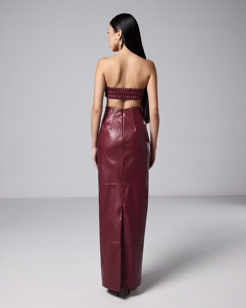 Back view of the burgundy leather maxi skirt and matching woven bandeau