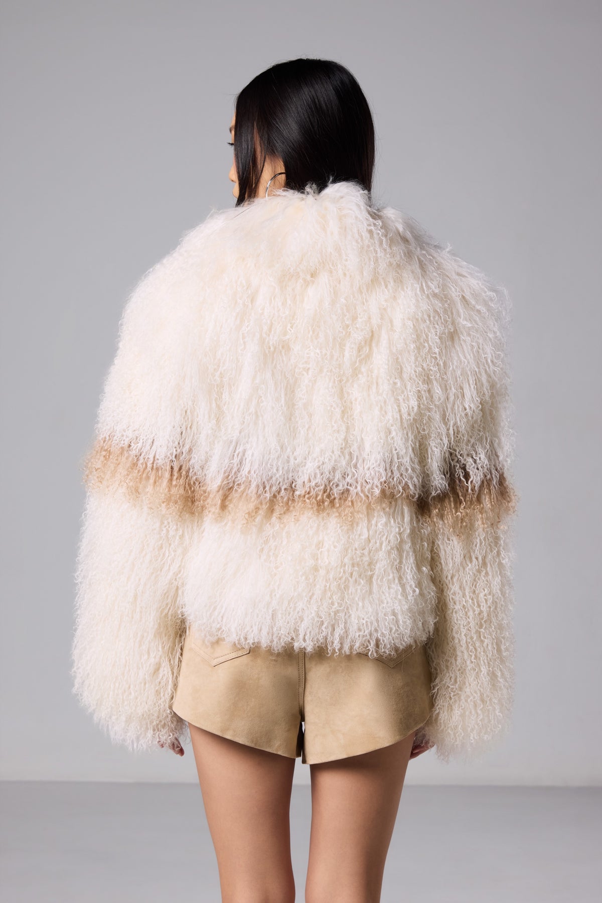 Nola Mongolian fur coat showing the warm brown stripe across the back