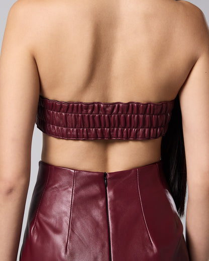 Burgundy woven bandeau with an elasticated back, styled with the matching leather skirt