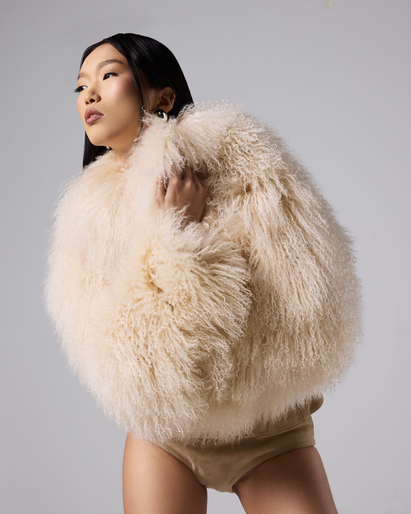 Sigrid Corset Mongolian Jacket in cream, showing the curly fur and fitted waist