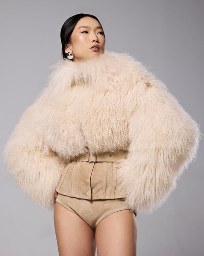 Sigrid Corset Mongolian Jacket in cream, showing the curly fur and fitted waist