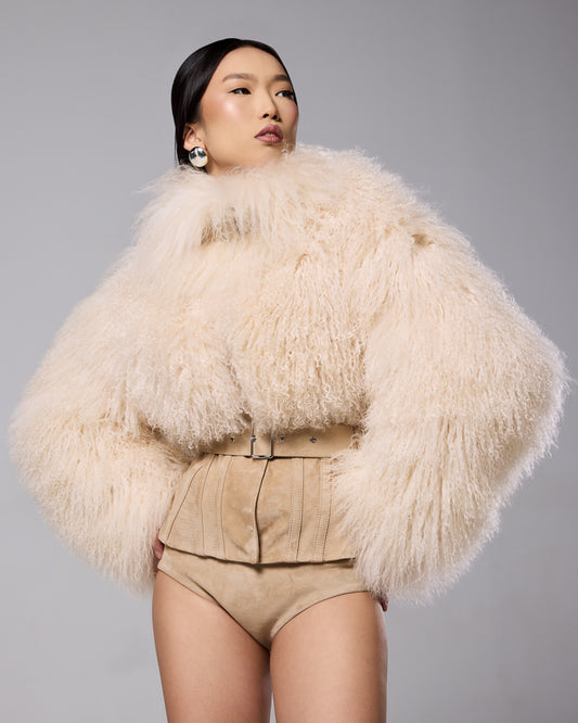 Sigrid Corset Mongolian Jacket in cream, showing the curly fur and fitted waist